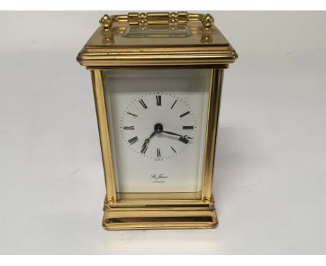 A brass cased Carriage clock with an enamel dial 11jewel Keywind movement, stamped St James London,