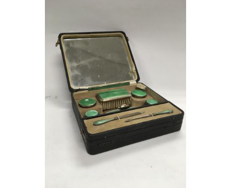 A 1920s cased silver and green enamel ladies travelling set (incomplete).
