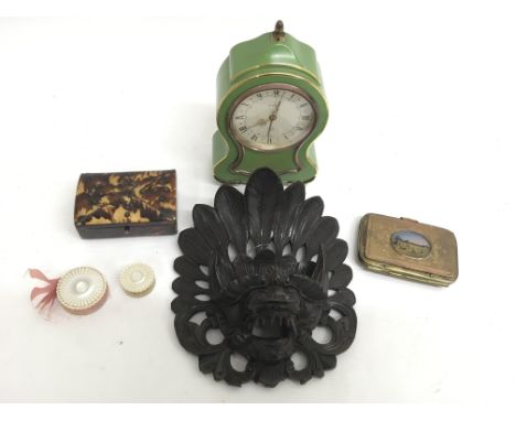 A tortoiseshell trinket box, a Victorian gilt metal coin purse, a carved wood mask of a mythical creature and green metal man