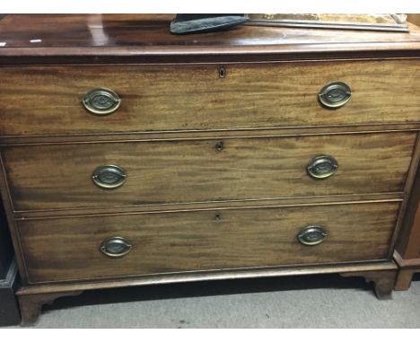 A late George III Mahogany chest of drawers the top with a crossbanded edge above three graduating drawers on bracket feet. 1