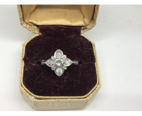 An Edwardian 18ct platinum gold ring set with floral diamond setting.Approx size K/J