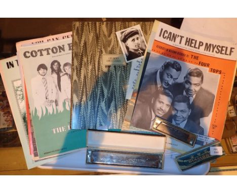 Two boxed harmonica and a collection of sheet music 