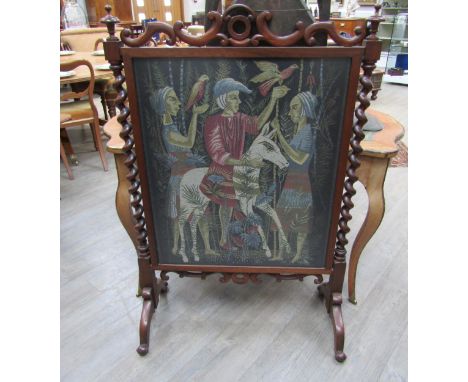 A rosewood fire screen with barley twist supports and finials on outswept feet, tapestry scene of figures surrounded by anima