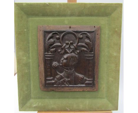 A 17th Century or earlier carved oak panel, mounted on green velour frame 23cm x 21cm 