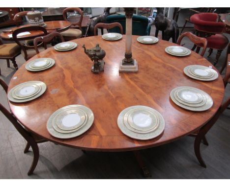 A Regency style yew wood circular dining table of large proportions. The top 182cm diameter on a four pillar quatraform base 