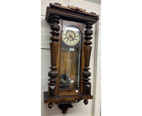 A vintage walnut cased Vienna regulator style wall clock with ornate pediment, visible pendulum and eight day gong striking m