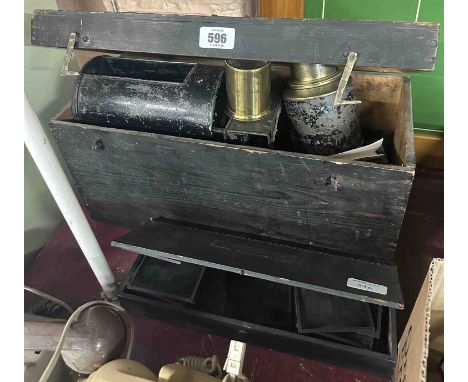 A wooden box containing an antique magic lantern - sold with a box containing a quantity of coloured slides including Louis W