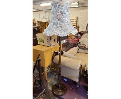 A vintage stained wood standard lamp with turned pillar, set on circular base - sold with shade