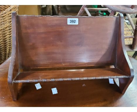 An early 20th Century stained walnut book trough with beaded decoration