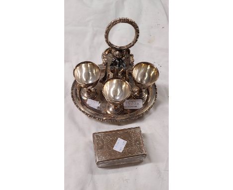 A silver plated egg cup set comprising four egg cups set on a stand with four teaspoons - sold with a glass trinket box with 