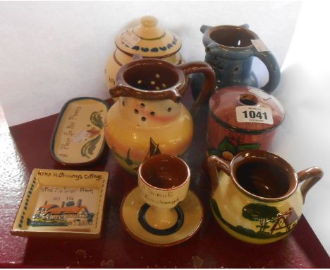 Eight pieces of Torquay and Devon pottery including Brannam puzzle jug, hair tidy, etc.