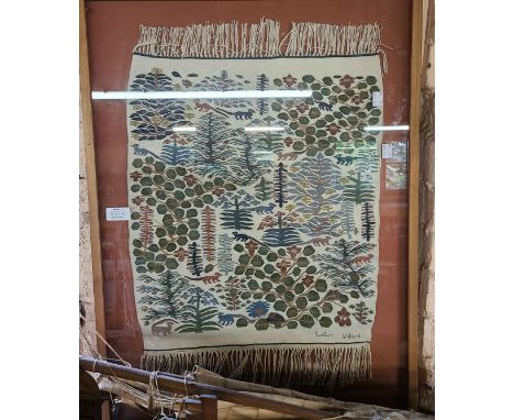 A small handwoven tapestry wall hanging with all over pattern depicting animals amidst trees - framed and glazed