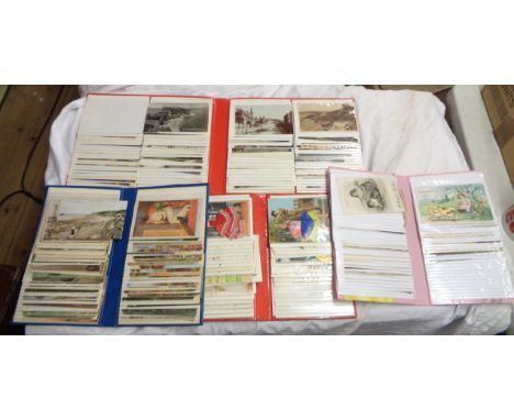 A box containing four postcard albums with various contents including greetings, etc.