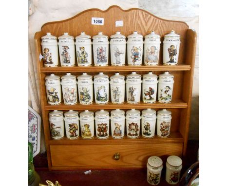 A 1980's Danbury Mint M.J. Hummel spice jar set comprising of twenty four named spice jars and a salt and pepper cruet, set o