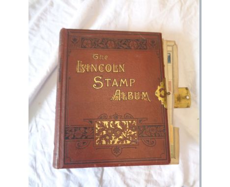 A red Lincoln Stamp Album containing 19th Century and later hinge mounted world stamps
