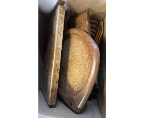 A box containing mixed woodenware items including salad servers, nut crackers, buddha figurine, etc.