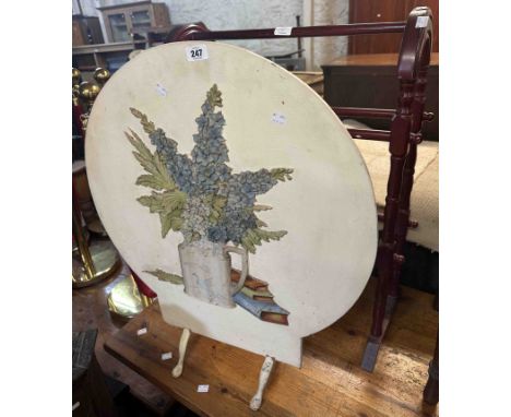 A circular fire screen with polychrome painted decoration, depicting flowers - sold with a stained wood double towel rail