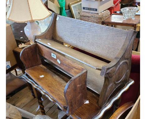 An early 20th Century oak book trough with carved petal decoration - sold with another