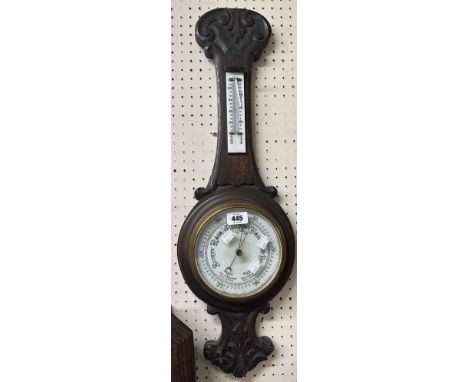 A late Victorian carved and stained oak cased aneroid banjo barometer/thermometer with printed white ceramic dial - thermomet