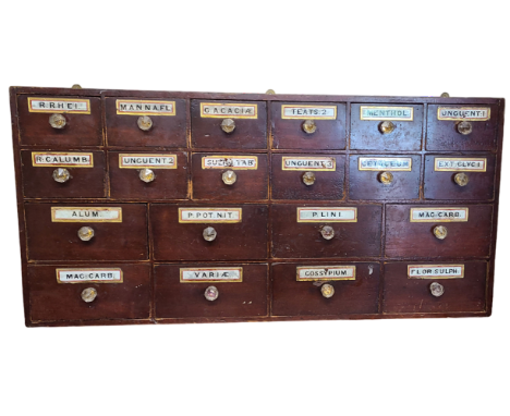 A 1.22m 19th Century stained mixed wood apothecary's chest with an array of twenty short drawers, each with original gilt gla