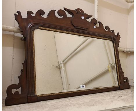A 1.08m late Victorian stained walnut framed overmantel mirror with ornate pediment and shaped bevelled plate