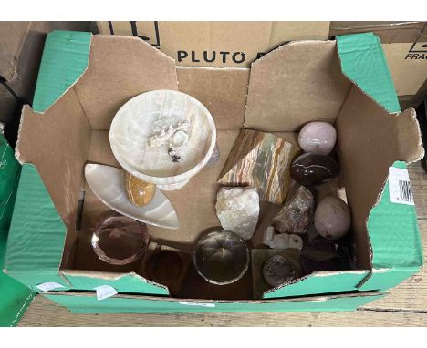 A box containing an onyx footed dish, an onyx pyramid, a selection of stone eggs, three faceted glass paperweights, etc.