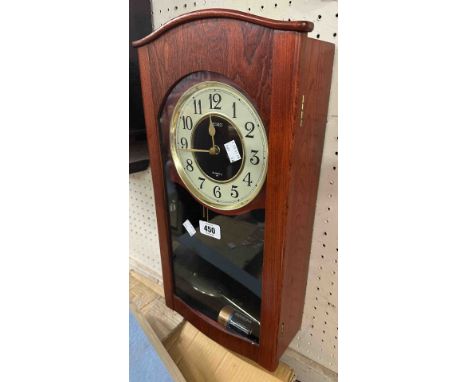 A modern Seiko stained wood effect cased wall timepiece with quartz movement