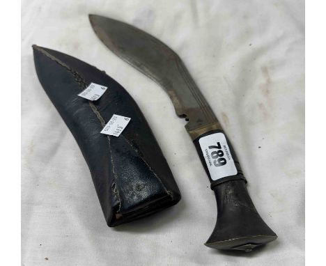 An antique Kukri knife in leather sheath