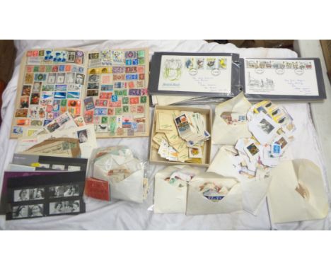 A ring bound album containing 1980's FDCs - sold with a Stanley Gibbons album with hinge mounted contents, various loose stam
