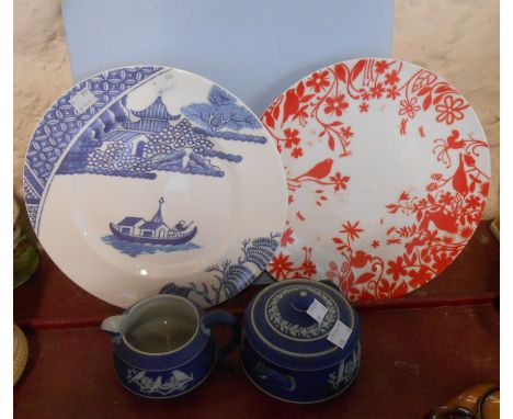 An early 20th Century Wedgwood dark blue jasper dip milk jug and sucrier - sold with a bone china plate in original box and a