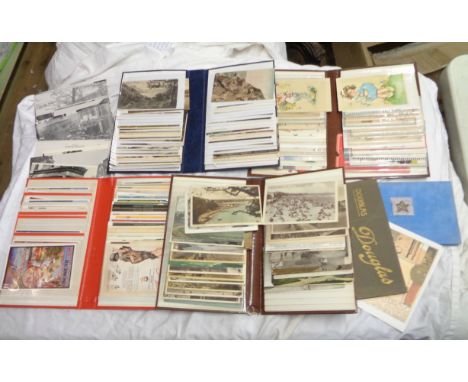 A crate containing various postcard albums, mostly with vintage contents, also a bag of monochrome photographs