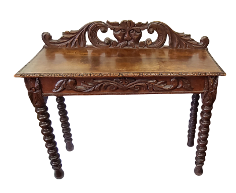 A 1.07m Victorian carved oak hall table with 'Green Man' raised back, set on bobbin turned legs