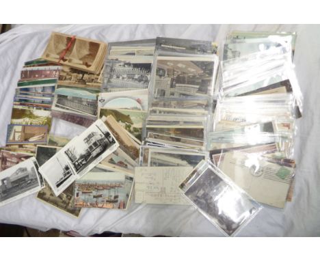 A shoebox containing a collection of plastic sleeved and loose early 20th Century and other postcards including local interes