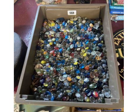 A crate containing a quantity of assorted glass marbles and pebbles