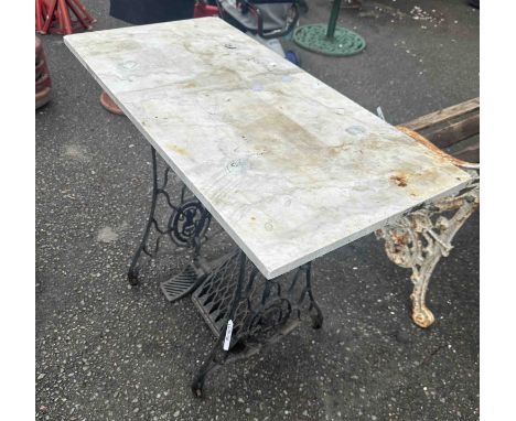 A 92cm marble slab, set on black Singer treadle sewing machine table base