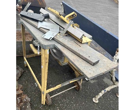 A painted metal portable circular saw bench