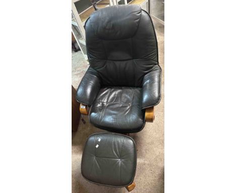 A modern easy chair with dark leatherette upholstery, set on a swivel base - sold with a similar footstool