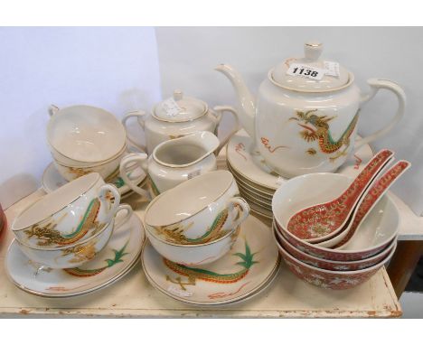 A Japanese eggshell porcelain tea set with 'Geisha' lithophane decoration comprising teapot, milk jug, sucrier, six cups and 