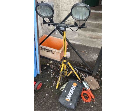 A halogen site light, a Worx multi-tool in case, a cordless screwdriver and a portable electric hanging lamp