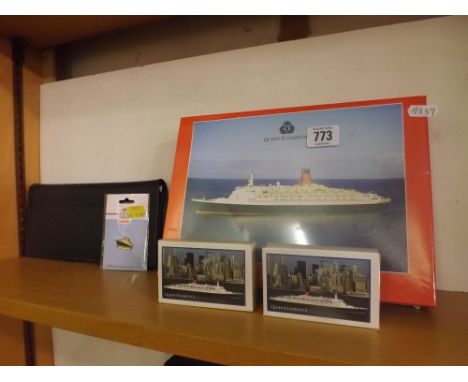 A SHELF CONTAINING QE II CUNARD SHIPPING LINE MEMORABILIA 