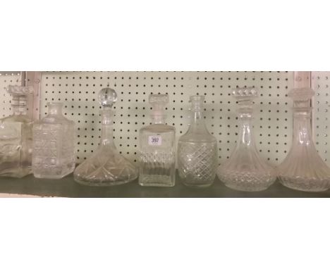 SHELF OF VARIOUS DECANTERS