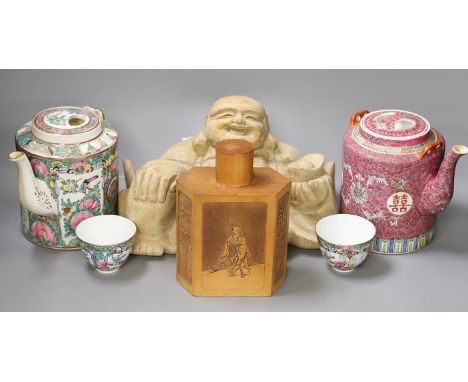 A Chinese wooden figure of Budai, two teapots in baskets and a tea caddy