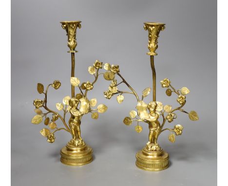 A pair of figural gilt metal candlesticks (Birmingham 1902 by Elkington &amp; Company and Chester 1922(?) by Haseler Brothers