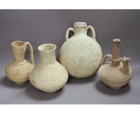 A group of Islamic terracotta vessels, Middle Eastern, possibly 12th century, including two jugs, an animal headed ewer and a