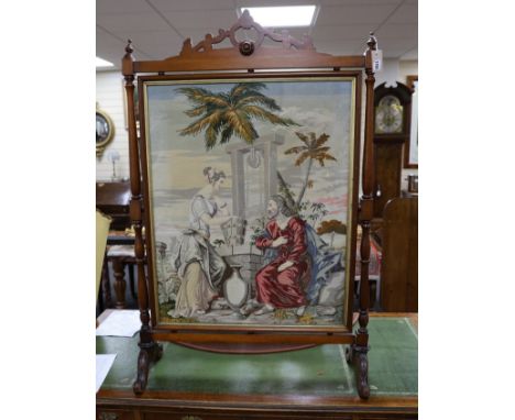 A large Victorian mahogany framed needlepoint firescreen, height 132.5cm high, width 86cm