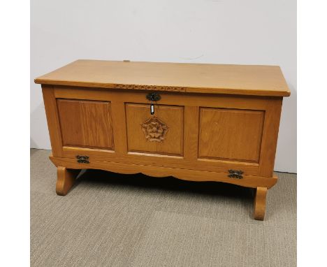 A carved light oak cabinet with drop down front, 112 x 47 x 61cm.