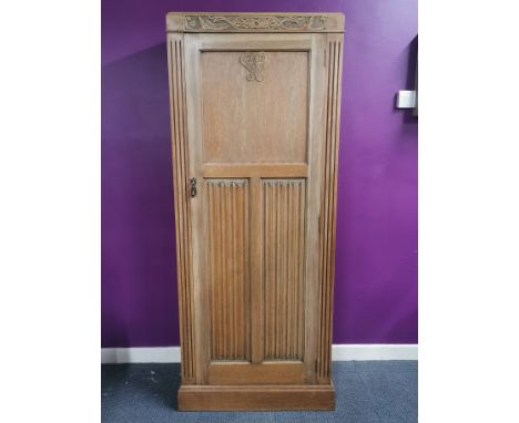 A carved light oak wardrobe with camphor interior, 180 x 38 x 72cm.