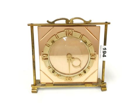 An Art Deco peach glass and gilt brass mantel clock with original electric movement, H. 19cm.