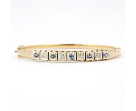 A 14ct yellow gold bangle set with rose cut diamonds and round cut sapphires, 6.5 x 6cm.