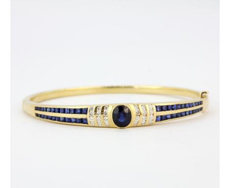 An 18ct yellow gold bangle set with sapphires and brilliant cut diamonds, 6.5 x 6cm.